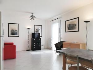 a living room with a table and a red couch at Residence Porto Sole in Cavallino-Treporti