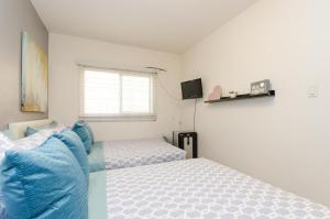 a bedroom with a bed and a television in it at Cute Studio in the Heart of Hollywood in Los Angeles