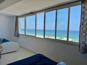 a bedroom with a window with a view of the beach at Studio with Stunning Sea View in Hammam Sousse