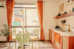 a small kitchen with a table and a window at Langmandi Experience Nhà Thờ in Hanoi