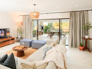 a living room with a couch and a table at Crane Song Cottage-Solar Power in Himeville