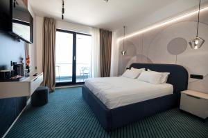 เตียงในห้องที่ Hotel Poem Eforie Nord - Roof Top Pool & Panoramic Sea View