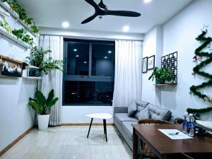 a living room with a couch and a ceiling fan at Gao's Bcons Garden Apartment in Dĩ An