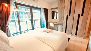 a bedroom with a bed and a large window at Studio Apartment KLCC Area in Kuala Lumpur
