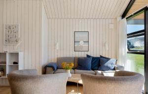 a living room with a couch and two chairs at Lovely Home In Stege With Sauna in Stege