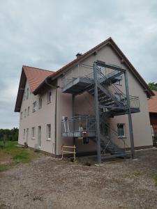 a building with a staircase on the side of it at Ferienwohnung LandZeit 2 in Schömberg