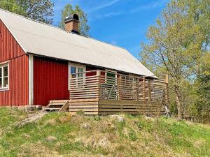 a red barn sitting on top of a hill at 6 person holiday home in Osby-By Traum in Osby