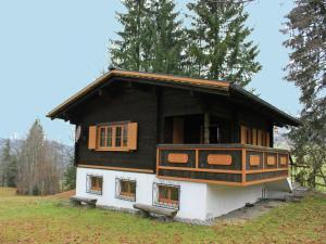 a small house on top of a grass field at Chalet in Sibratsgfäll near Ski Slopes in Sibratsgfäll