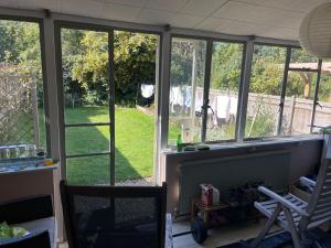 a room with windows with a view of a yard at Central Sevenoaks townhouse in Sevenoaks