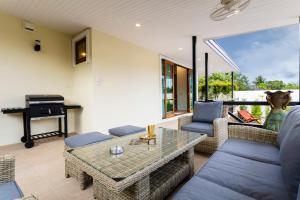 a living room with a couch and a table at Arabella Ao Nang Private Pool Villa in Ao Nang Beach