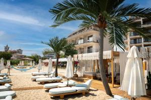 a group of lounge chairs and umbrellas on a beach at Sunny Beach Vila in Sunny Beach +72 photos