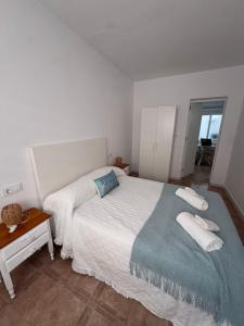 a bedroom with a bed with two towels on it at Mar azul in Puerto de Mazarrón +11 photos