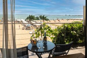 a table with a bottle of wine on the beach at Sunny Beach Vila in Sunny Beach