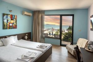 a bedroom with a bed and a view of the ocean at Sunny Beach Vila in Sunny Beach