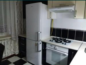 a kitchen with a white refrigerator and a stove at Квартира in Bilhorod-Dnistrovskyi