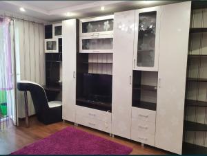 a white cabinet with a tv in a room at Квартира in Bilhorod-Dnistrovskyi