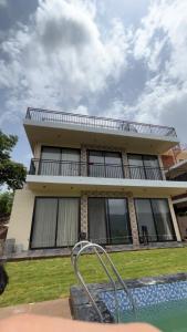 a house with a swimming pool in front of it at Nuwara Eliya Karjat - 5BHK Villa in Karjat