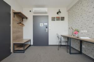 an office with a blue door and a desk at Kremowa Residence by Solarento in Warsaw