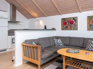 a living room with a couch and a table at Bright Family Cottage by Kelstrup Beach in Kelstrup Strand