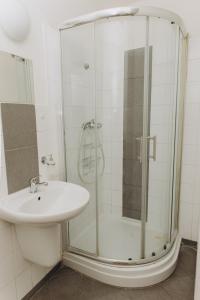 a bathroom with a shower and a sink at Sleep & Go Czech Republic - Praha 5 Anděl in Prague +20 photos