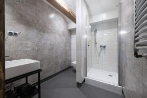 a bathroom with a sink and a shower and a toilet at Gospoda Dębowiec520 in Bielsko-Biała
