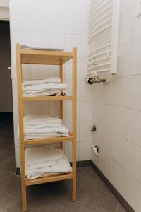 a shelf with towels on it in a bathroom at Sleep & Go Czech Republic - Praha 5 Anděl in Prague