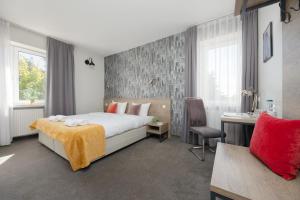 a bedroom with a bed and a desk and a chair at Kremowa Residence by Solarento in Warsaw