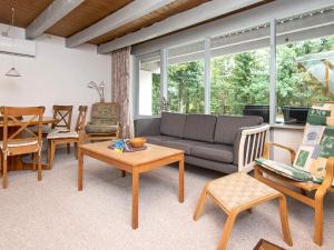 a living room with a couch and chairs and a table at 5 person holiday home in Ebeltoft-By Traum in Øksenmølle