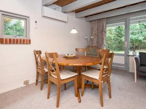 a dining room with a wooden table and chairs at 5 person holiday home in Ebeltoft-By Traum in Øksenmølle