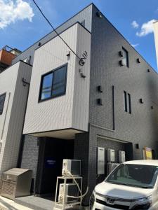 a white car parked in front of a building at PRISM Inn Tateishi in Tokyo