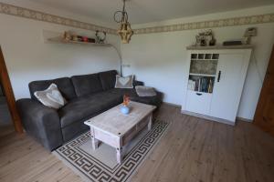 a living room with a couch and a coffee table at Cottage Sächsische Schweiz in Pirna