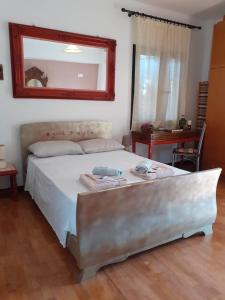 a bedroom with a bed with a mirror on the wall at Corfu Cosy Apartment by the Nature in Kato Korakiana