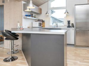 a kitchen with a counter and a refrigerator at 10 person holiday home in Harboøre-By Traum in Harboør +27 photos