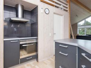 a kitchen with a stove and a counter top at 10 person holiday home in Harboøre-By Traum in Harboør