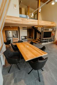 a large room with a wooden table and chairs at Tihuta Chalet in Piatra Fantanele +42 photos