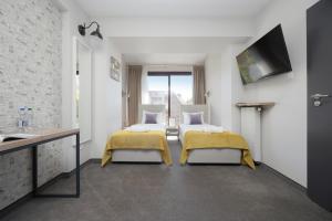 En eller flere senge i et værelse på Kremowa Residence by Solarento