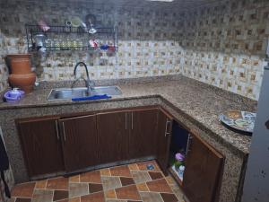 a kitchen with a sink and a counter top at La Pause Dar Bouazza in Tamaris