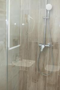 a shower with a glass door in a bathroom at Готельний комплекс GАРБУЗ in Zwiahl +59 photos