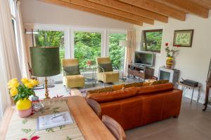 a living room with a couch and a table at B&B de Hinne in Holten