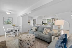 a living room with a couch and a table at Barefoot Bungalow in New Smyrna Beach