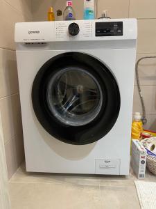 a white washing machine sitting in a kitchen at La Sirena in Kladovo +11 photos