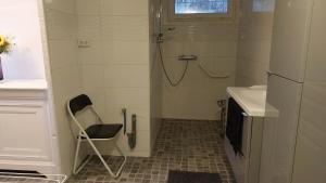 a bathroom with a shower and a chair in it at chambre dans villa in Marseille +16 photos