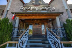 a building with stairs leading to the entrance to a restaurant at Kremowa Residence by Solarento in Warsaw