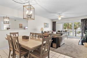 a dining room and living room with a table and chairs at Maravilla 3202 in Destin