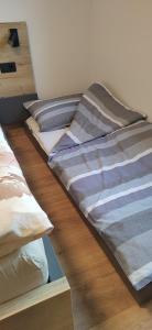three beds sitting on the floor in a room at MaxLux Apartments in Slovenj Gradec +3 photos