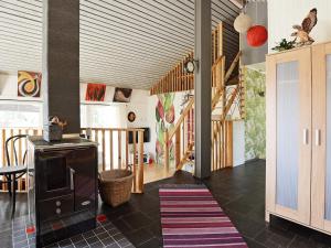 a living room with a rug on the floor at 5 person holiday home in RYSSBY in Ryssby +16 photos