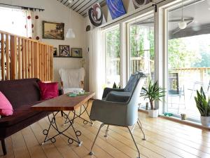 a living room with a couch and a table at 5 person holiday home in RYSSBY in Ryssby