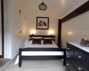 a bedroom with a bed with two lamps on it at Errekarteko-borda in Saint-Jean-le-Vieux