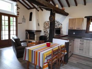 a kitchen with a table with a table cloth at Errekarteko-borda in Saint-Jean-le-Vieux