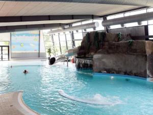 a water slide in a pool in a building at Seaside Escape in Ho - By Traum Ferienwohnungen in Ho